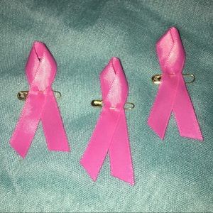 Three breast cancer awareness ribbon pins